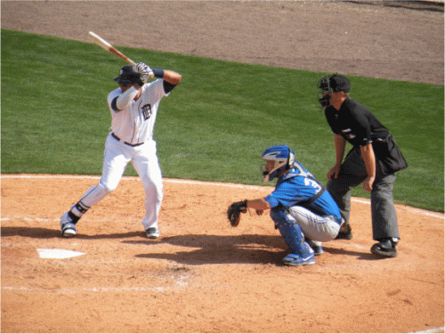 Swing-batter - batter at home plate with Major League baseball in Lakeland Florida